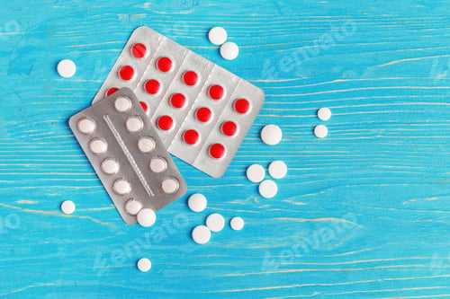 Preview: Many different pills on dark blue wooden background