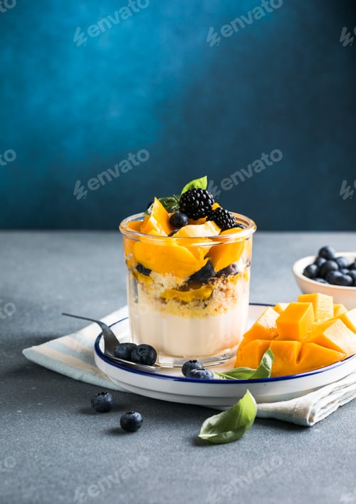 Preview: Trifle dessert with berries and cream on wooden table. Copy space