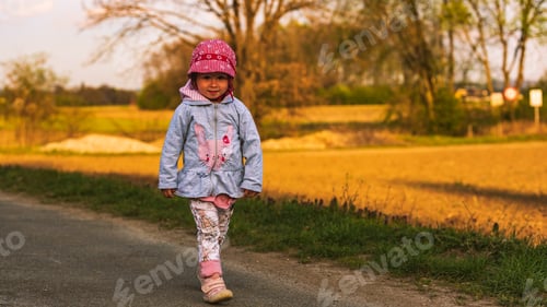 Preview: Cute little girl having fun at countryside portrait on sunset