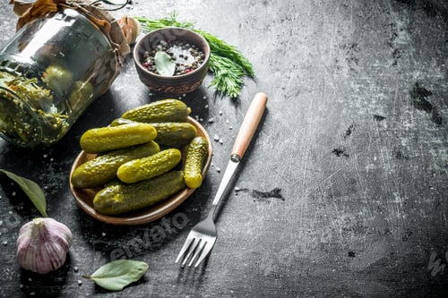 Preview: Preserved homemade cucumbers on a plate with a fork.