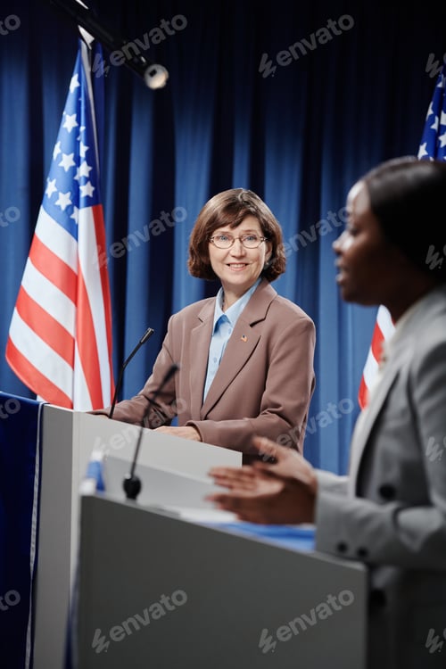 Preview: Smiling mature delegate at conference
