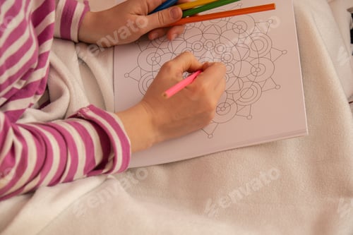 Preview: Female painting mandalas antistress page to combat stress. Relaxing hobby mental wellbeing and art