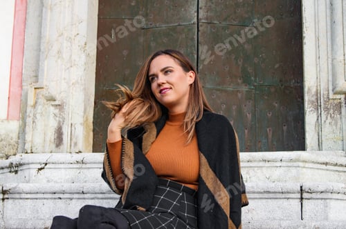 Preview: Woman Sitting on Steps in Historic Building