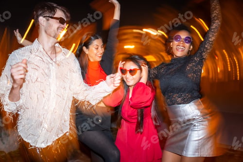 Preview: Four multi-ethnic friends partying in the street at night