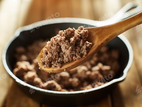 Preview: spoonful of freshly cooked ground beef from iron skillet