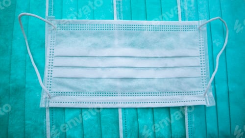 Preview: Close-up of medical mask green on a white background. A disposable masks