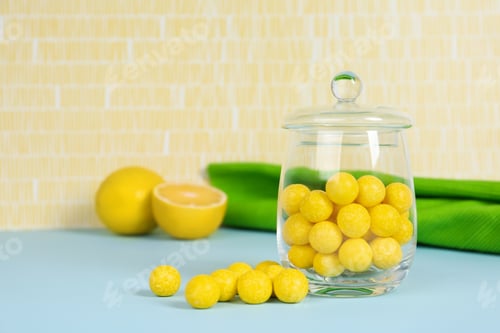 Preview: Delicious lemon drops on blue table. Space for text