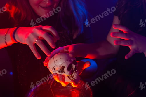 Preview: Two halloween witches making magic in halloween night. Magic, holidays and mystic concept.
