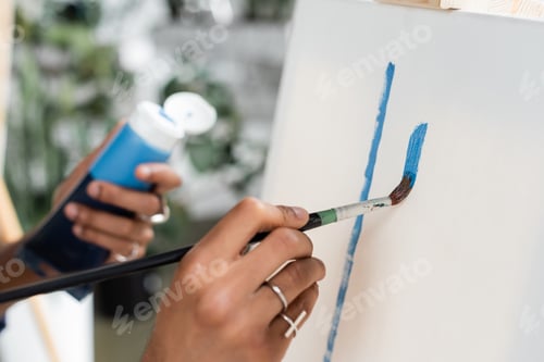 Preview: Cropped view of african american artist painting on canvas in workshop