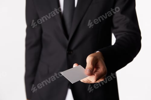 Preview: cropped image of businessman giving empty business card isolated on white background