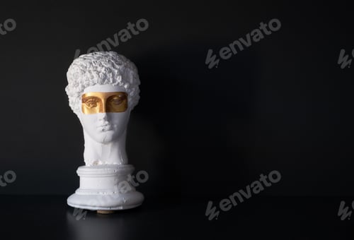 Preview: Classical white bust with golden eye masks on black background in moody lighting.