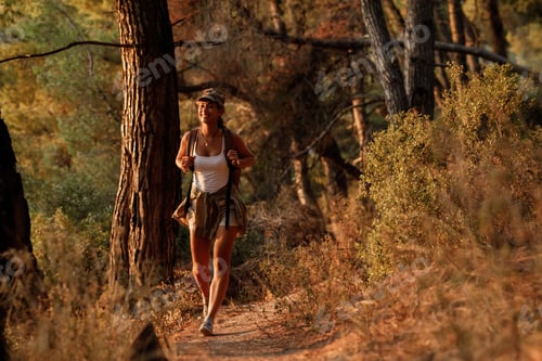 Preview: Young smiling woman hiking in the mountains.