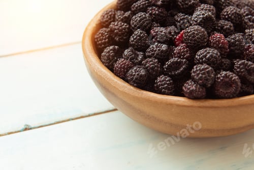 Preview: Ripe fresh blackberries in a wooden bowl on the table