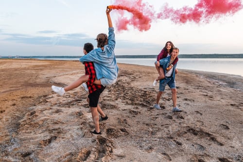 Preview: young friends running with hand flare or fusee