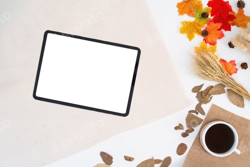 Preview: Workspace with blank copy space tablet mockup, notepad, blanket, envelopes, coffee cup, leaves on