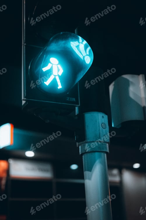Preview: Vertical shot of a green traffic light for pedestrians.