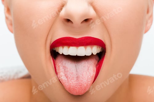 Preview: cropped view of young woman with red lipstick sticking out tongue isolated on white