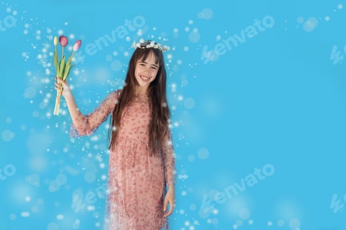 Preview: happy girl with flowers laughs in the beautiful glare of the rays of spring. spring mood
