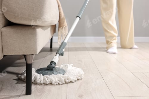 Preview: Woman cleaning floor with string mop indoors, closeup