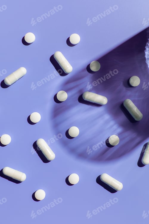 Preview: Various vitamins and pills on a purple background. Medicine, treatment and health.