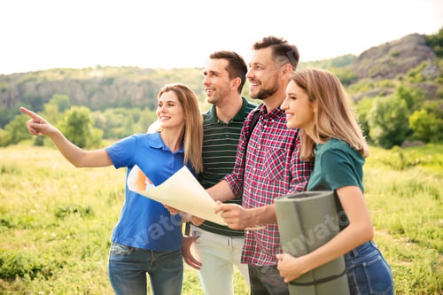 Preview: Young people exploring map in wilderness. Camping season