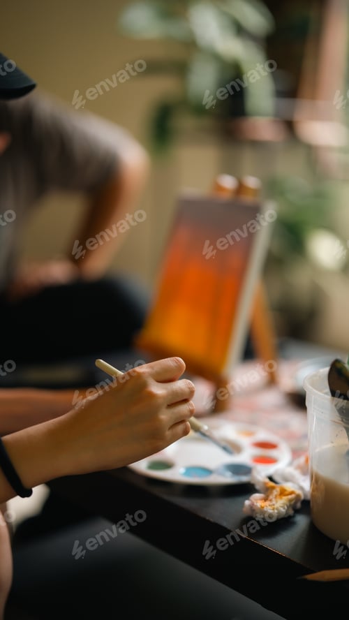 Preview: Happy moment cute girl creating and water color painting activity with paint brushes on frame canvas