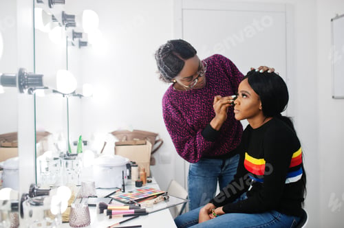 Preview: African American woman applying make-up