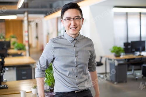 Preview: Young man standing in office