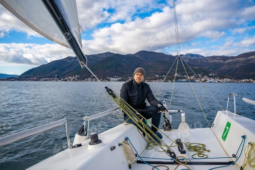 Preview: Man sailing a sports yacht in the Kotor Bay, Montenegro, showcasing adventure, freedom, and nautical