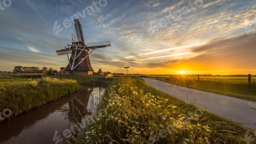 Preview: Wooden windmill along cycling track at sunset