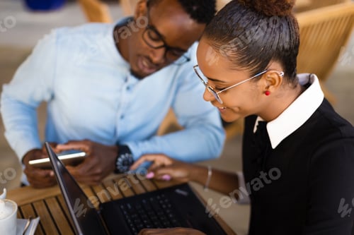 Preview: Black African American coworkers doing digital teamwork arround