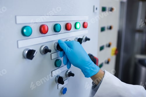 Preview: Hand with gloves turning buttons of the machine in the factory