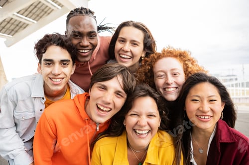 Preview: Multiracial group of young friends taking selfie portrait together outside