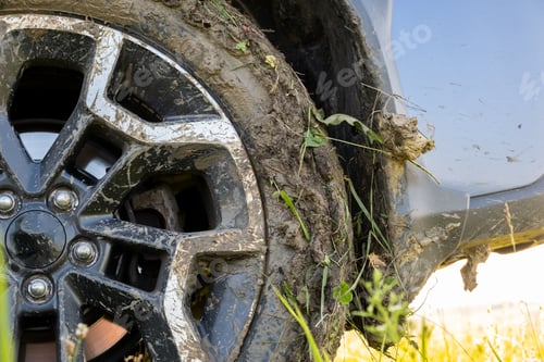 Preview: Close up of dirty off road car wheels with dirty tires covered with yellow mud