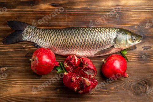 Preview: top view fresh fish with pomegranates on a wooden desk food ocean sea seafood