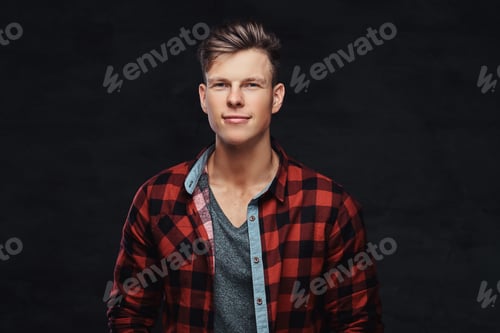 Preview: Portrait of a smiling fashionable young guy in a fleece shirt, posing at a studio.