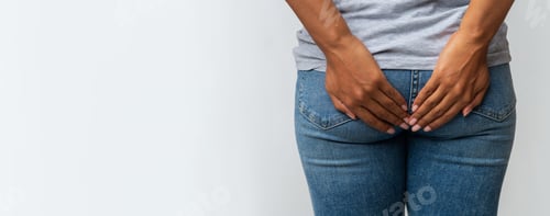 Preview: Woman with hemorrhoids holding her butt in pain