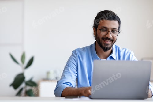 Preview: Recruitment Concept. Smiling Eastern Guy Using Laptop, Searching Jobs Online In Internet