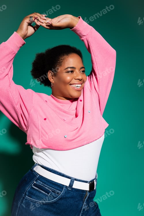 Preview: Stylish plus size woman showcasing trendy autumn fashion in a vibrant studio setting