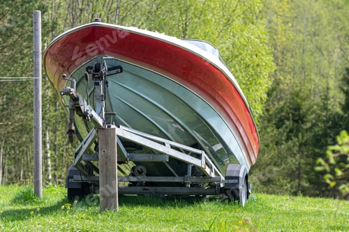 Preview: A motorboat on a trailer on a green meadow