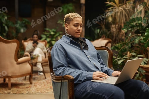 Preview: Black Girl with Short Hair Using Laptop in Vintage Office