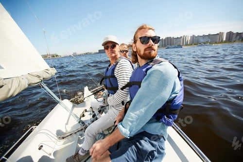 Preview: Men in life jackets sitting on yacht
