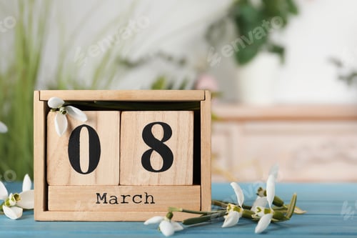 Preview: Greeting card for Women's Day. Beautiful snowdrops and wooden calendar on table