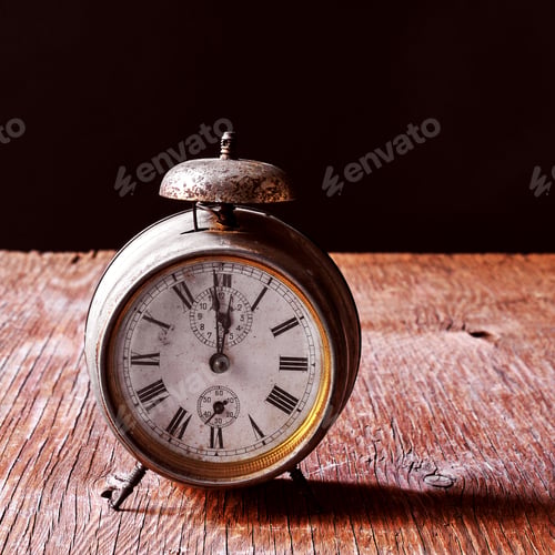 Preview: A Rusty Old Alarm Clock On A Rustic Wooden Table, With A Black Background