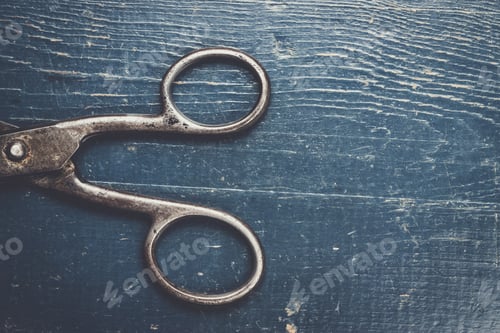 Preview: old scissors on the wooden background