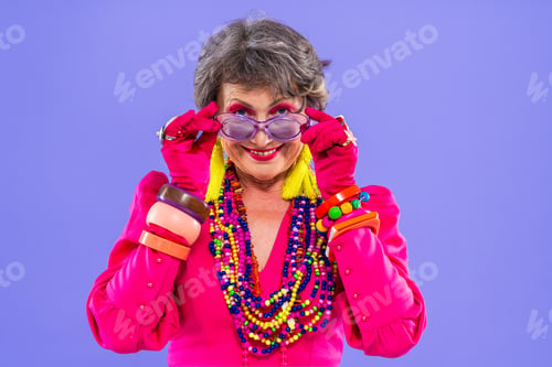 Preview: Happy and funny senior old woman on colorful background