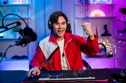Preview: Portrait of Asian esport male gamer playing video game on computer.