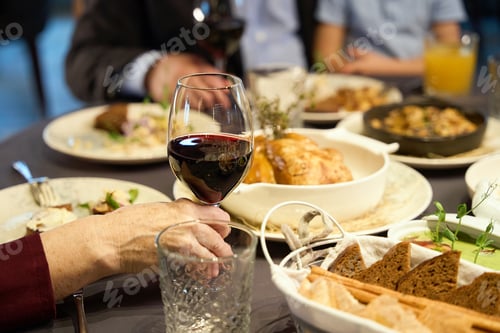 Preview: Hand of old woman holding glasses of wine, enjoying of celebration