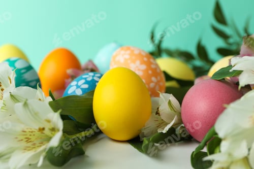 Preview: Color Easter eggs and alstroemeria flowers against mint background