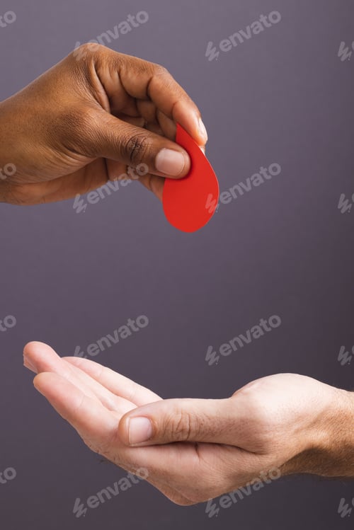 Preview: Hands of biracial man giving blood drop to caucasian man, on grey background with copy space